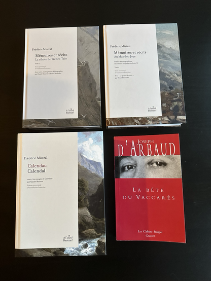 Four books: “Calendau” by Mistral, “Mémoires et récits” (two volumes) by Mistral, and “La bête du Vaccarés” by Joseph d’Arbaud