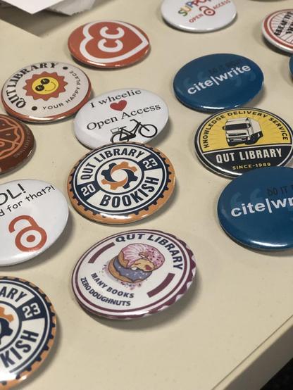 Collection of badges with QUT Library, open access, cite write referencing and others.
