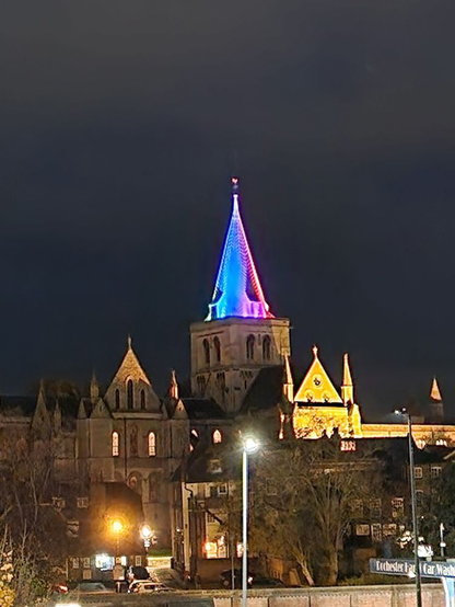 A picture of the spire of Rochester Cathedral lit up for Trans Remembrance Day.