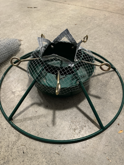 Wire mesh molded around the bowl of my Christmas tree stand, the top opening up like a chicken wire flower and edged in duct tape.