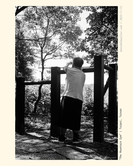 A man doing exercise at an outside gym at the top of Elephant Mountain in Taipei.