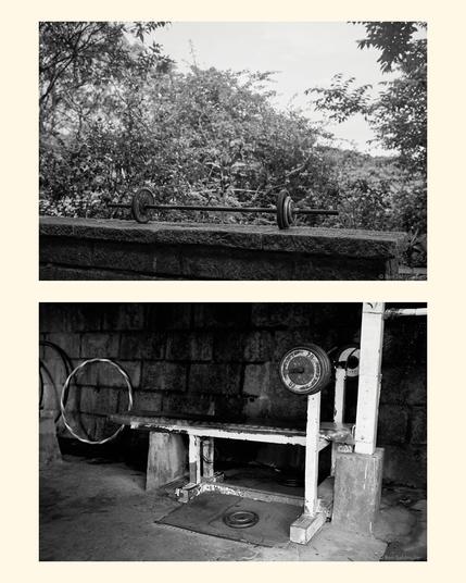 Two images
- A makeshift weightlifting rack and bench outside on Taipei's Elephant Mountain.
- An iron bar with weights, lying outside on top of Taipei's Elephant Mountain.