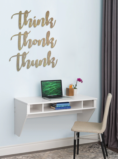 digital mockup of a small wall desk with a laptop and some flowers on it. a chair is set to the side and on the wall is some sparkly gold wood blocks of text that reads "think thonk thunk"