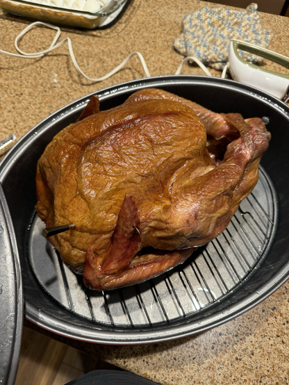 A smoked turkey sitting in a pan