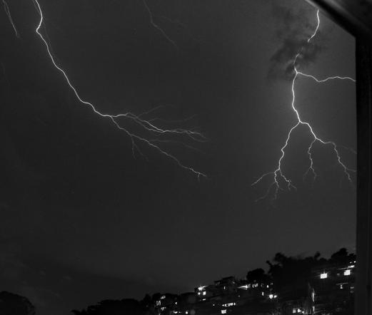 A lightning seen from my window in the sky over the nearby favela community, representing the more frequent than ever thunder storms going on, probably due to climate changes. This month I saw more lightning than all the years I've been living in this place.