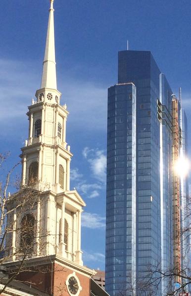 The multi-tiered spire of the Park Street Church (1810) and the glass Millennium Tower (2016) rise into the sky together.