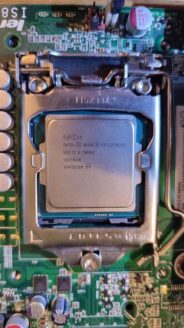 Close-up of the processor socket on the M93p's motherboard, with the Xeon E3-1275L V3 in place. The CPU bracket has closed, holding the new processor in place.