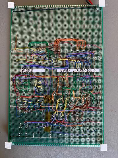 Back of the veroboard Cosmicos showing an insane amount of hand wired soldered connections in a variety of colours.