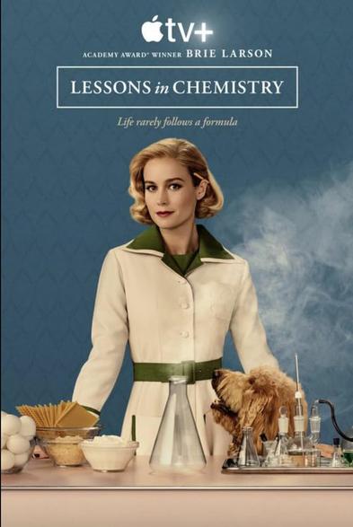 Brie Larson on the Lessons in Chemistry poster. She's behind a counter with food on one side and science equipment on the other side.