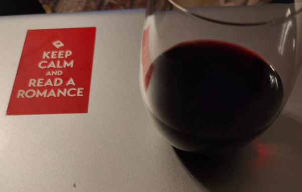a Keep Calm and Read Romance sticker and a glass of red wine.