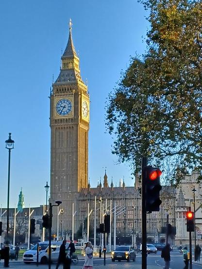Westminster Tower (AKA 'Big Ben') with a clear blue sky behind it, one face is in shadow and the other is brightly lit by a brilliant, late autumnal, morning sun.