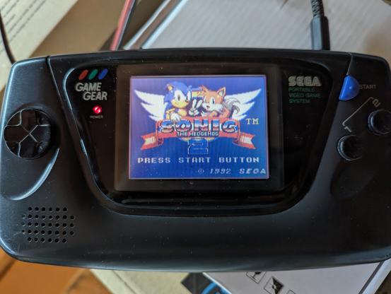 GameGear sitting on a pile of boxes, turned on, and running Sonic 2.
The image is now decent