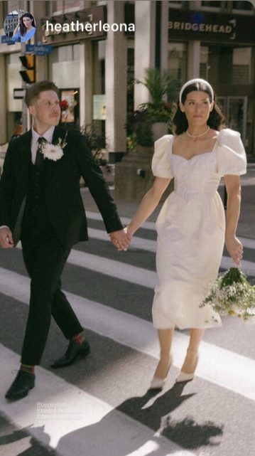 A man and woman holding hands showing the changes in the dress to shortened gathered sleeves, and sweetheart neckline and raised waist seam