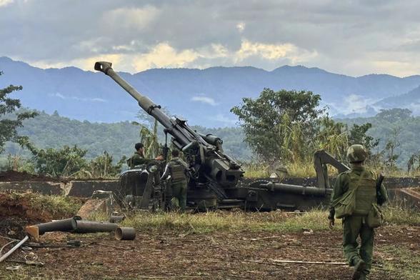 this photo provided by the Kokang online media, members of an ethnic armed forces group, one of the three militias known as the Three Brotherhood Alliance, check weapons the group allegedly seized from Myanmar's army outpost on a hill in Hsenwi township in Shan state, Myanmar, on Nov. 24, 2023. A major offensive against Myanmar's military-run government by an alliance of three militias of ethnic minorities has been moving at lightning speed, inspiring resistance forces around the country to attack. (The Kokang online media via AP) © Provided by The Associated Press