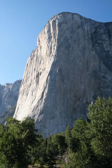 A tall granite rock, backlit by the afternoon sun.