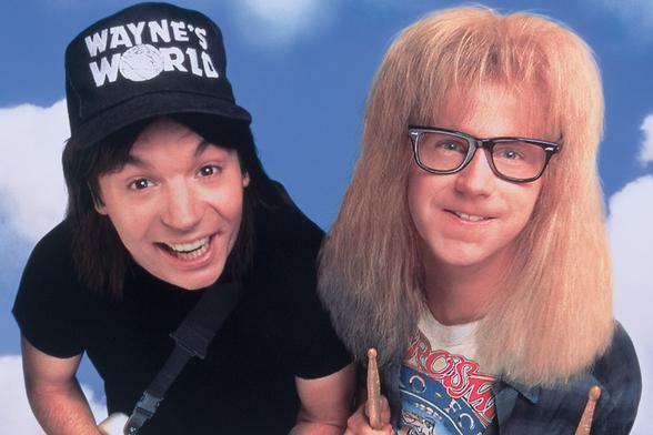Mike Myers (as Wayne) and Dana Harvey (as Garth) look up at the camera while promoting the movie "Wayne's World".