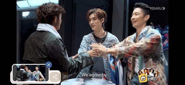 Danzel, Ding and Vanness clasping hands over a table, all happy. caption "we agreed'.