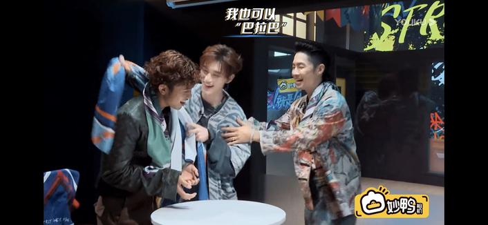 Ding drapes a towel around Danzel, who already has Vanness's towel around his neck. Vanness is grabbing Ding's arm.