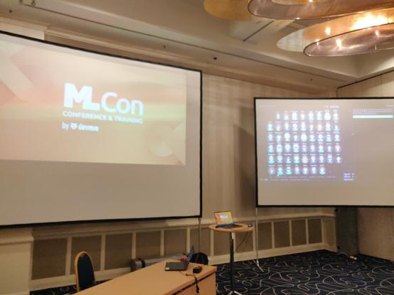 The conference stage with presentation and live audience wall.