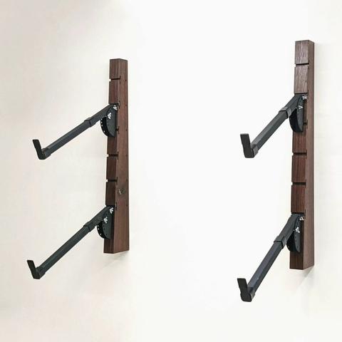 Four keyboard racks hang on corresponding solid walnut wall supports.
