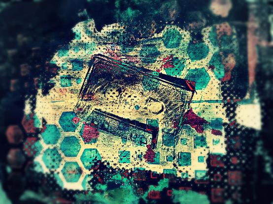 Abstract art with an impression of a cassette tape in the middle over a cream background with teal hexagons and a dark blueish green grungy border.