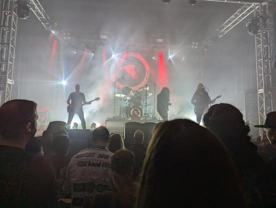 Katatonia on stage, lots of smoke and white and red lights. They have their bird logo in the back