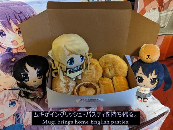 Mugi, Mio, and Azura plushies are posed with English pasties.