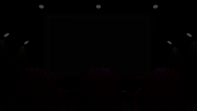 A Theater room that is dimly lit.