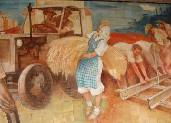 Happy workers in an idealised agrarian and industrial landscape, with a blue sky.