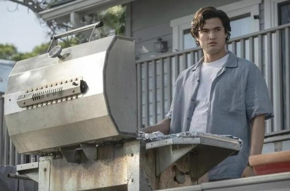 Charles Melton may be the one getting the Oscar nom for this film He's in a blue shirt standing in front of a gas outdoor grill.