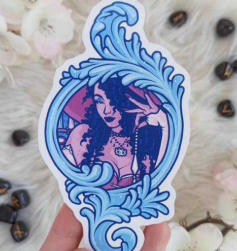Vinyl sticker of a mirror with a witch holding a pendulum in her hand.