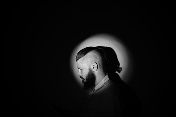 A silly side-profile self-portrait of me with shaved side of head and a short ponytail.