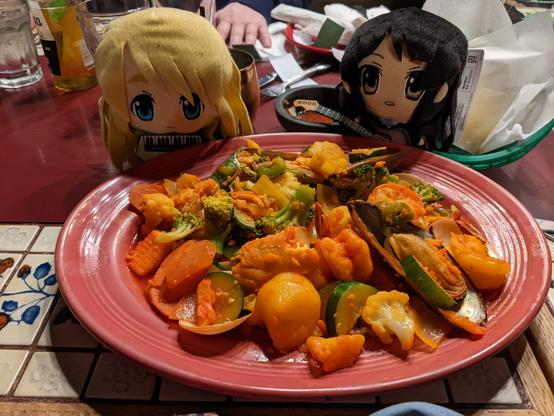 Mugi and Mio look at plate of Mexican food, a mixed seafood.