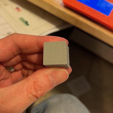 Base of a 3D printed calibration cube. Slightly bumpy (as you'd expect from a textured plate) but nicely consistent.