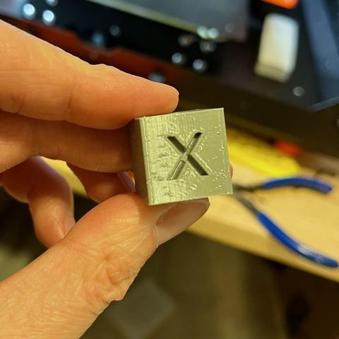 Side view of the calibration cube (X side). Decent print but looks like some tiny missing areas in some of the horizontal rows.