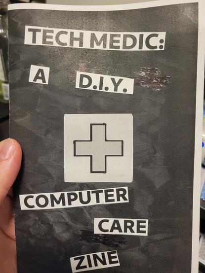 A zine master version. Black cover with awhite border with text from printed text and the medical cross icon glued to it. 

In order of sequence:

Teach medic:
A DIY
*cross icon*
Computer
Care
Zine