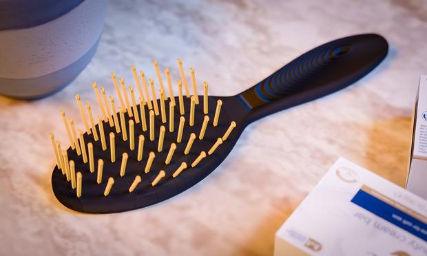 A render of a 3d-printed hair brush with textures that resemble a 3d-print.