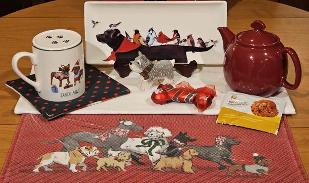 A tea tableau featuring dogs in Christmas regalia, and Honeybush Banana Nut tea from Adagio.