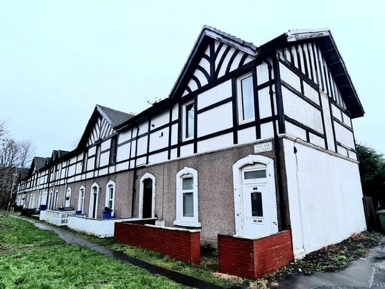 A terrace of half-timbered two-bedroomed houses close to the banks of the Clyde in the west of Glasgow.