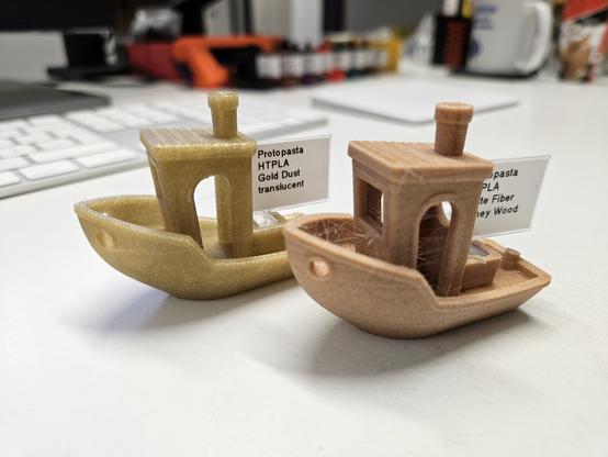 Two 3D printed ships in different materials.