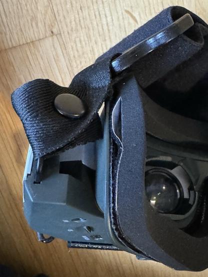 Photo, close up. Replacement foam padding installed to the HDZero goggles. A clear gap can be seen on the left side where the a velcro strip is supposed to be glued to the foam padding. The rest of the velcro is glued on properly.