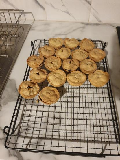 A batch of delicious mince pies, fresh out of the oven and baked from scratch.