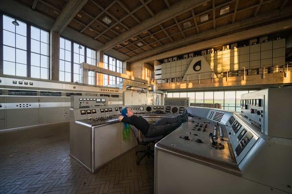 abandoned industry, a curved center console with a girl posing asleep in the chair with her feet on the console