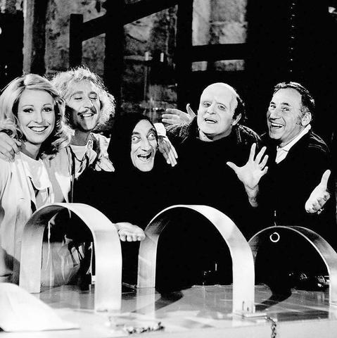 The cast of Young Frankenstein with Mel Brooks. From left to right, Teri Garr, Gene Wilder, Marty Feldman, Peter Boyle, and Mel in front of the mad scientist table.