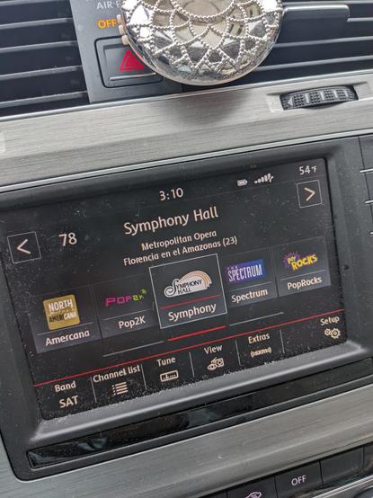 Photo of my car radio. The Sirius XM station called Symphony Hall is playing the Metropolitan Opera's 2023 production of Florencia en al Amazonas.