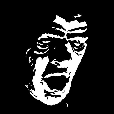 Pen drawing of a monstrous face drawn on a black background.