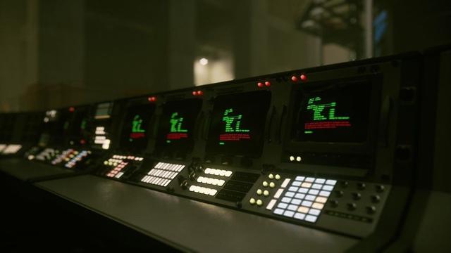 A bank of consoles seen at an angle.
