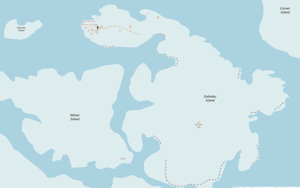 Map of Galindez island, shaded light grey in a light blue sea with the location of Woozle hill and Vernadsky Station marked