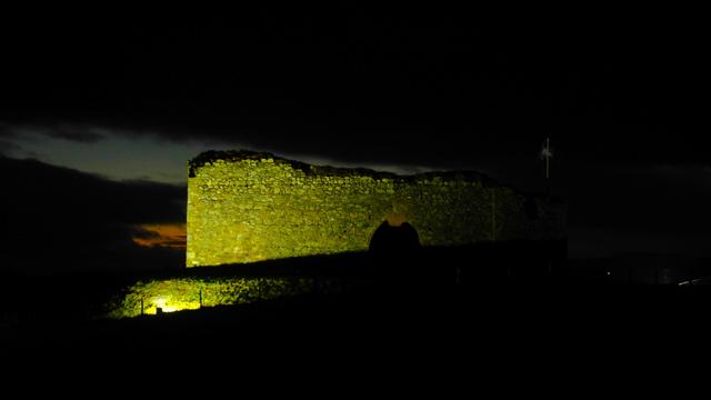 Remains of 1,000 year old castle lit up with yellow light