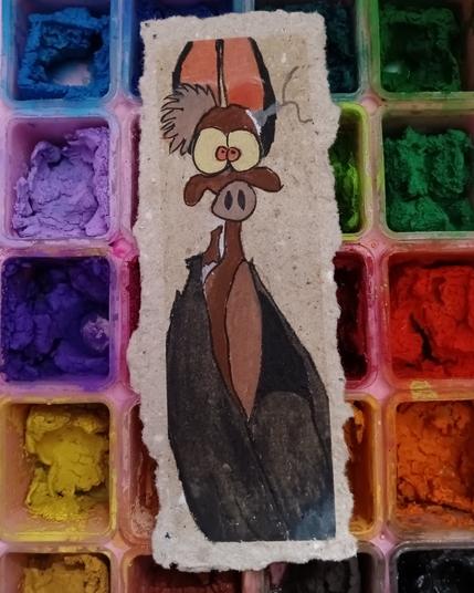 A small painting of the character Batty, from Ferngully, is resting on a dried and colourful paint palette.